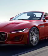 Red Jaguar F-Type cabriolet driving trough serpentine 