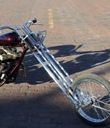 custom motorcycle parked on a brick road