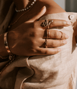 a woman's hands holding a cross on a dress shirt