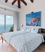 a bedroom with a large painting on the wall