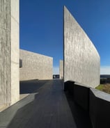 photographer landscape picture of a long narrow walkway with a long wall between two art structures
