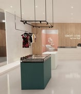 a storefront of a clothing store with a variety of clothes and accessories