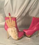 a pair of pink boots with a handmade finger - like finger - like finger