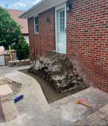 a large rock formation in a backyard with a large rock