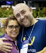 a man and woman are smiling and hugging