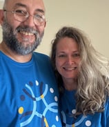 a man and woman in matching blue shirts