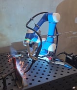 a robot is welding a metal frame