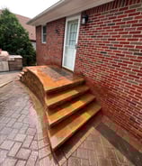 a brick wall with a brick wall and stairs
