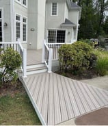 a white house with a white railing and a white railing