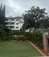 a house with a lawn and a fenced in area