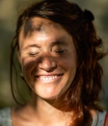 a woman with red hair and a smile on her face