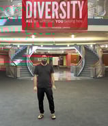 Koshish Foundation scholar standing outside a modern campus building.
