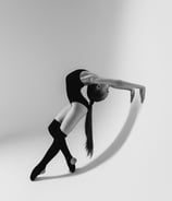 A gumnast is showing the back flexibility