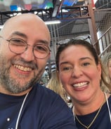 a man and woman smiling and posing for a photo