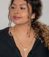 a woman with a black shirt and gold jewelry