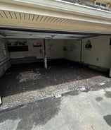 a garage with a garage door open and a garage door open