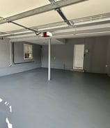 a garage with a garage door open and a garage door open