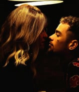 a man and woman kissing in a dark room