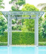 Modern pergola structure creating shade in garden by Garden Designers