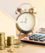 a house with a calculator and coins