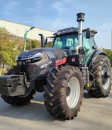 a 260HP tractor with a large tire on the side of the road