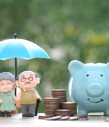 a happy old couple after retirement with the pile of money showcasing financial security