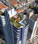a tall building with a pool in the middle of it