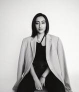 a woman sitting on a chair with her legs crossed