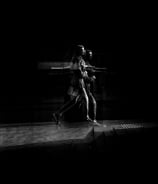 Two people walking, distorted through glass. The Usher Hall, Edinburgh