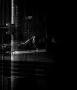 A man, with a ghost like shadow, taken through glass at The Usher Hall. Edinburgh