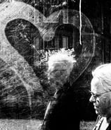 Two women walk past a bus shelter on Palmerston Place, Edinburgh