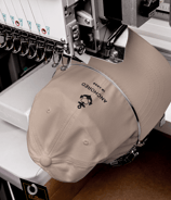a beige cap being embroidered with anchor design