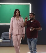 a man and woman standing in front of a green screen