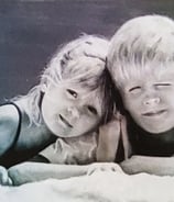Siblings rendered in soft tones like a quiet chord of warmth and innocence