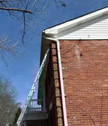 installing seamless k style gutters on a. brick two story home