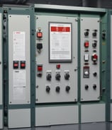 An electrical panel with multiple Category 6 (CAT 6) ethernet cables plugged into ports labeled from A to G. The cables are of different colors, including black, green, red, and blue, organized neatly into corresponding outlets. The panel includes labels for 'LINE OUT' and 'LINE IN' and the brand name 'Teka' is visible.