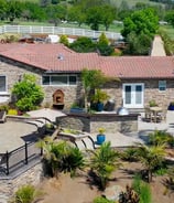 a house with a pool and a fenced in area