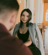 a woman in a black top and a man in a gray jacket