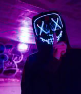 a person wearing a mask mask and a black hoodie