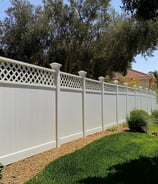 a vinyl fence with a lattice design on top