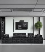 A person wearing a white mask is interacting with a network server, handling blue cables. The setup is illuminated with blue lights, suggesting a technological environment.