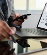 a man in a suit and tie is holding a cell phone