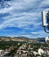 a cell phone phone tower with a antenna on top of it