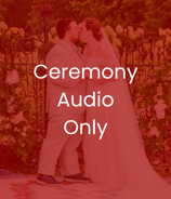 a bride and groom kissing in front of a fenced in area