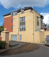 blonde stone apartment block on a bright summer day