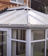 a white conservatory attached to a house