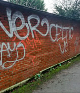 a brick wall with graffiti on it