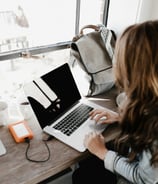 A woman typing on a computer. Photo by Andrew Neel on Unsplash