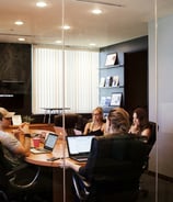 Four people in a conference room in a meeting. Photo by Campaign Creators on Unsplash