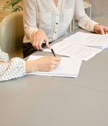 An image of two people working on paperwork. Photo by Gabrielle Henderson on Unsplash